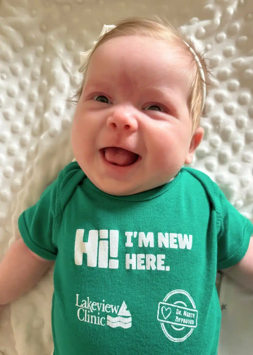 NB.91825 Green Lakeview onesie on blue background.