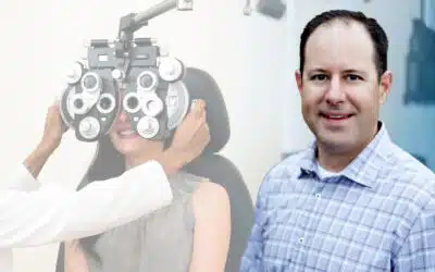 Dr. Thomas Bryan in with a patient having an eye exam.
