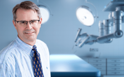 Lakeview General Surgeon, Todd Elftmann in front of the Da Vinci Robotic surgical system.