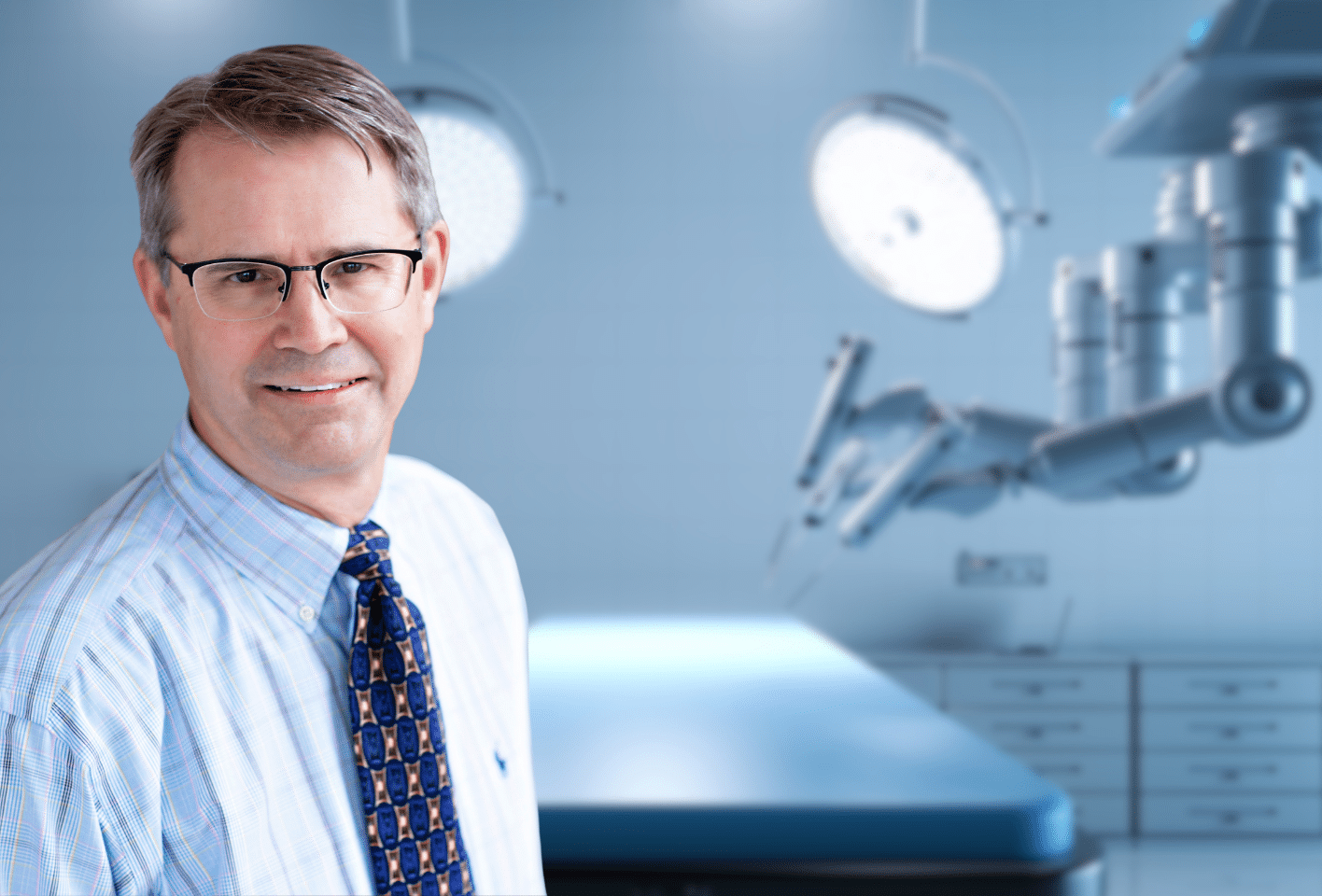 Lakeview General Surgeon, Todd Elftmann in front of the Da Vinci Robotic surgical system.